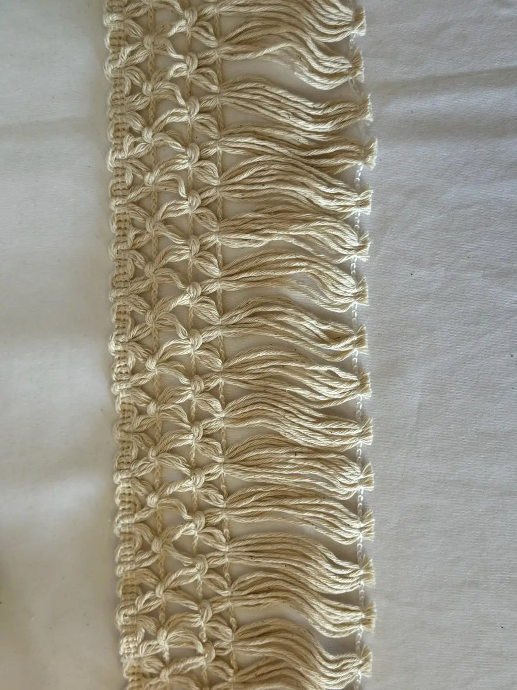 Cream-colored bordadura estelar macrame fringe trim with woven pattern and tassels made of 80 cotton by l&l