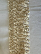 Cream-colored bordadura estelar macrame fringe trim with woven pattern and tassels made of 80 cotton by l&l