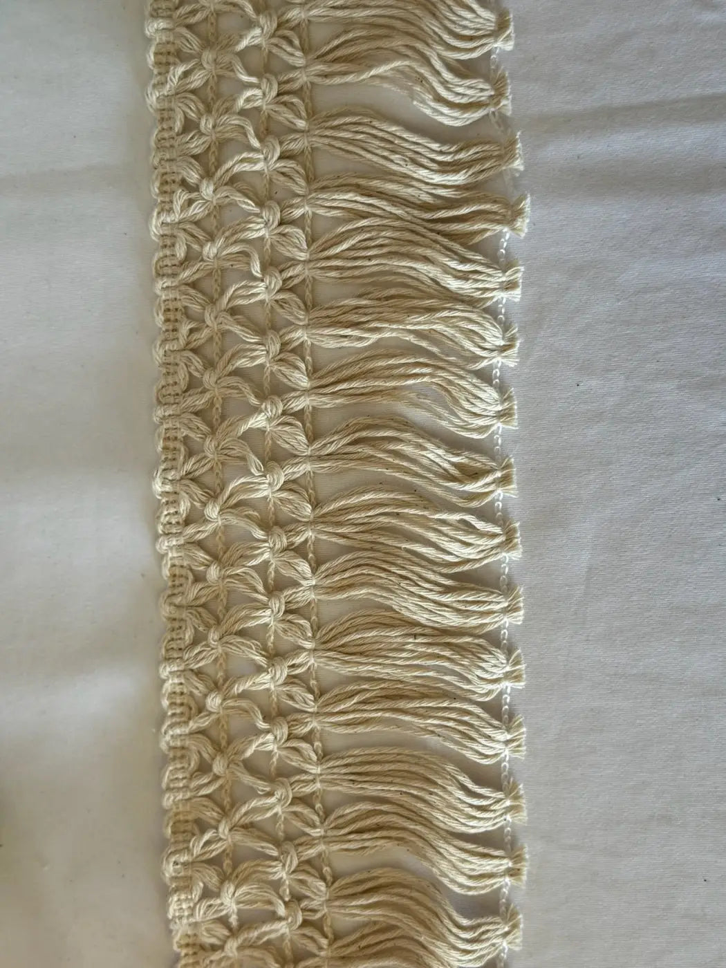 Cream-colored bordadura estelar macrame fringe trim with woven pattern and tassels made of 80 cotton by l&l