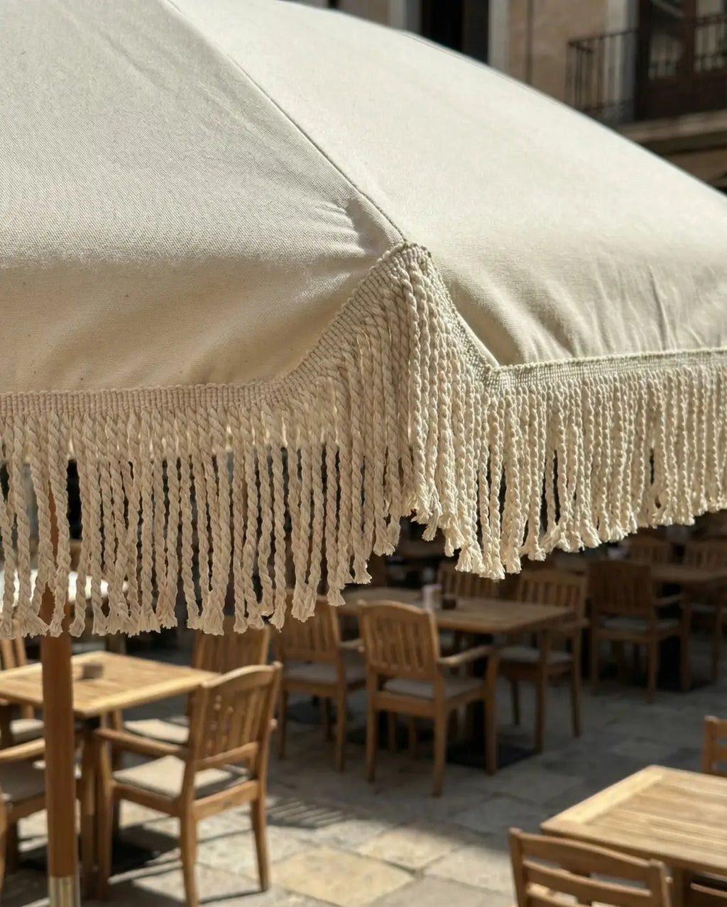 Cream-colored canvas patio umbrella with decorative macrame fringe franja manto alma estrutural l&l in algodão 80% natural