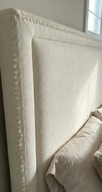 Beige galão ducale bed headboard with decorative lace trim brilho metálico and nailhead alma estrutural detailing